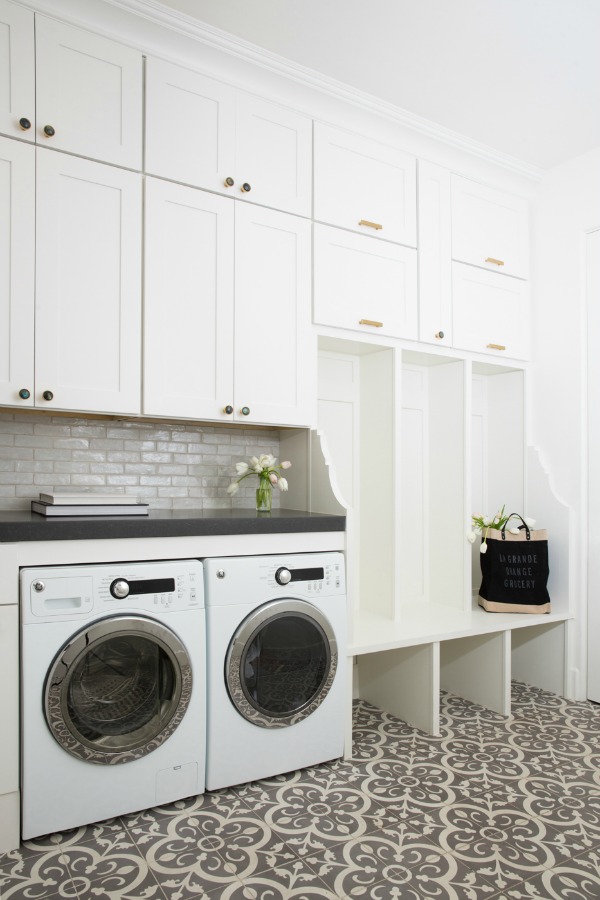 Modern farmhouse laundry room with built-ins, decorative Moroccan style tile floor, and subway tile backsplash - Jaimee Rose Interiors.