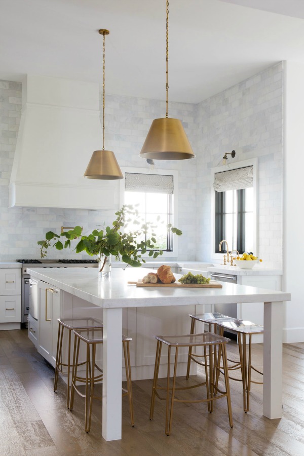Marble subway backsplash taken to ceiling in a lovely custom modern farmhouse kitchen with brass accents - Jaimee Rose Interiors.