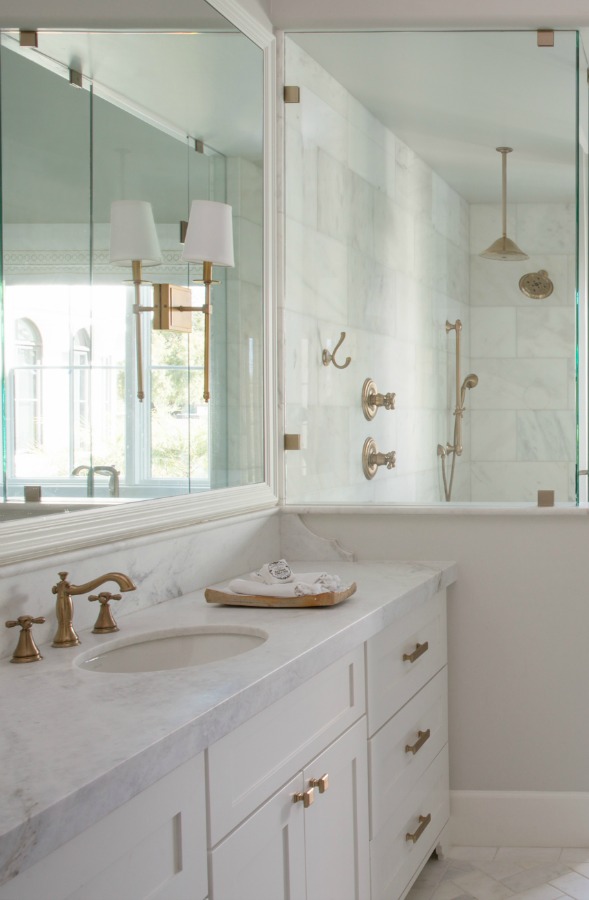 Beautiful white modern farmhouse bathroom with freestanding tub and herringbone tile floor - Jaimee Rose Interiors. #bathroomdesign #interiordesign