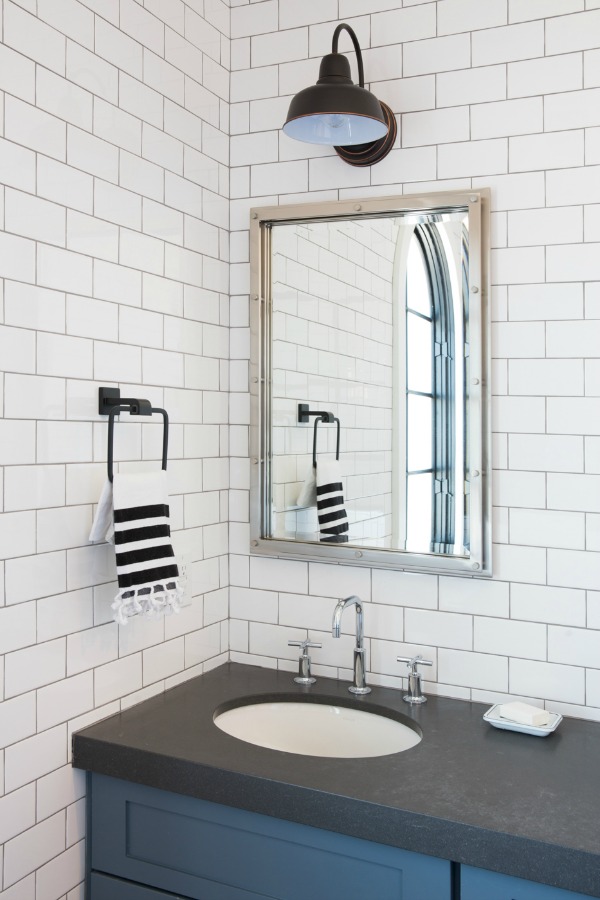 Modern farmhouse bathroom with subway tile and black vanity top - Jaimee Rose Interiors.