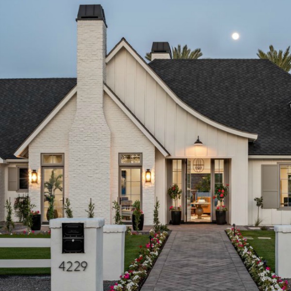 Classic white modern farmhouse exterior with classic Tudor influence. #interiordesign #modernfarmhouse #houseexterior