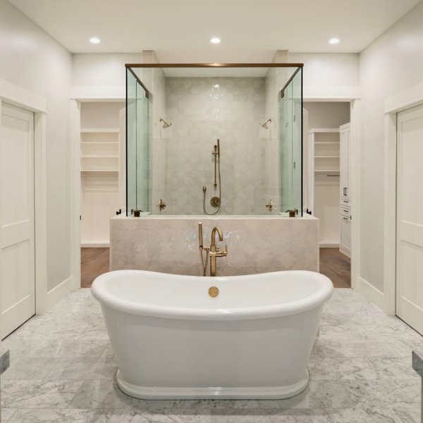 Luxurious white marble bathroom with glass enclosure for shower and soaking tub with brass fixtures - Jaimee Rose Interiors.