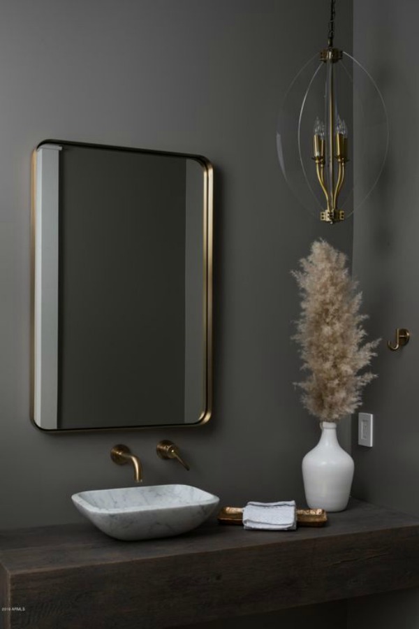 Moody dark grey-taupe walls in a modern rustic bathroom with marble vessel sink and brass wall mount fixture - Jaimee Rose Interiors.