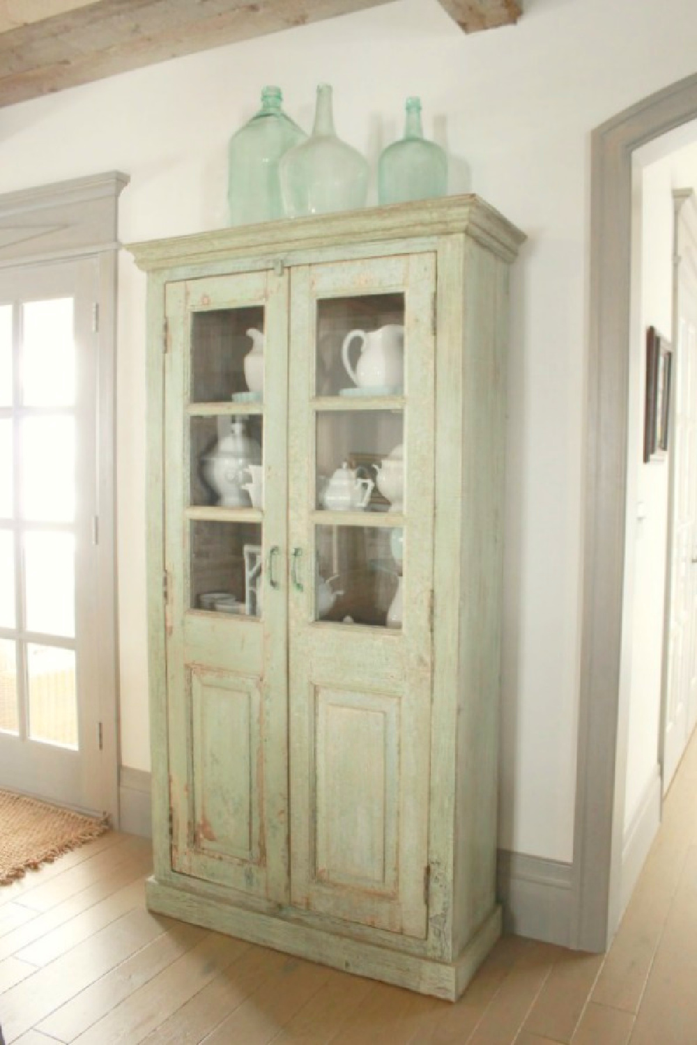 Tall antique green cabinet in rustically elegant European country cottage - Desiree of Beljar Home and DecordeProvence. #europeancountry #cottagestyleinteriors