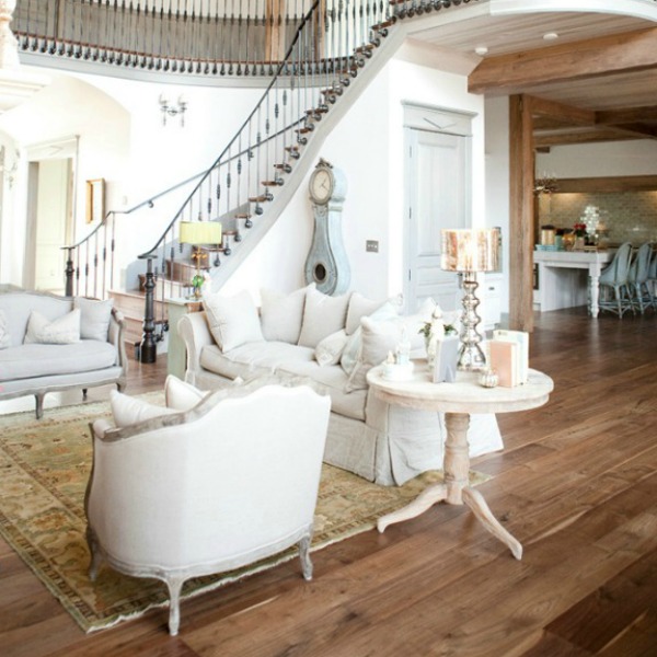 Walnut floors in living room with magnificent French staircase - come tour French Fantasy House Build: A Timeless Tranquil Home Favorite!