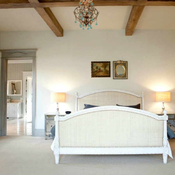 Simple white French bedroom with pale blue-grey stained trim around door - come tour French Fantasy House Build: A Timeless Tranquil Home Favorite!