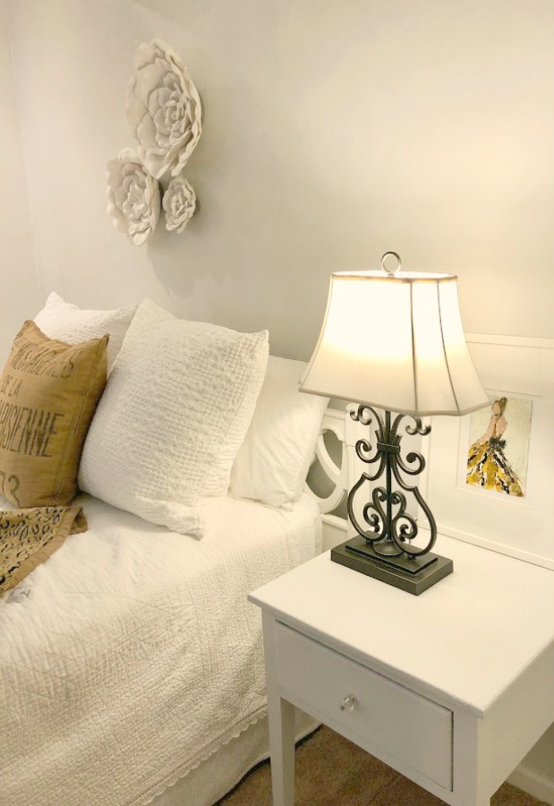 Bedroom with accent wall painted BEHR Sterling at 50% for a very pale blue-grey.