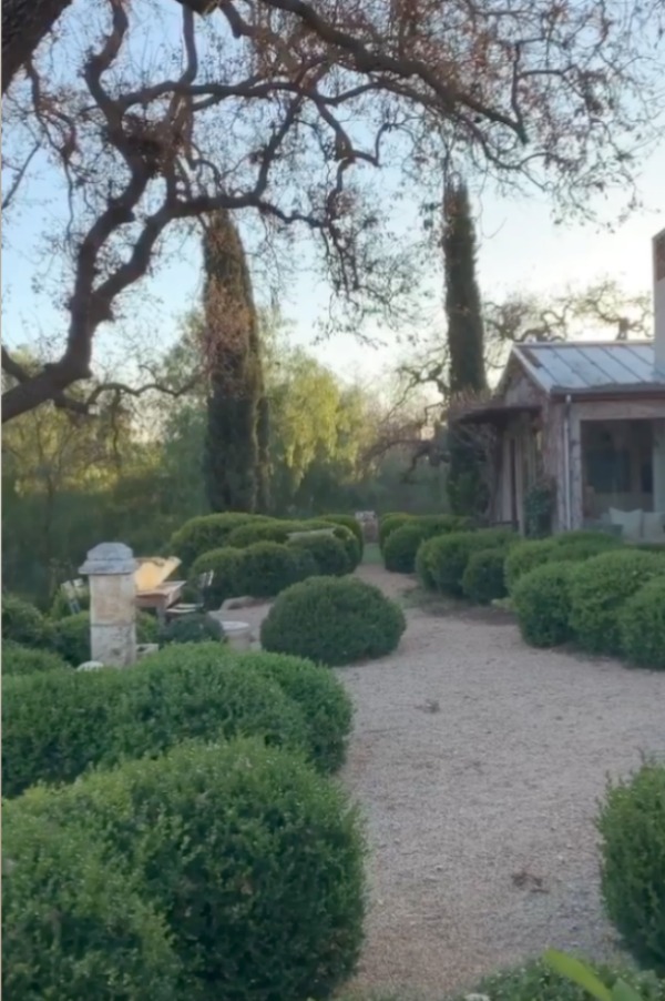 Beautiful French farmhouse style gardens at Patina Farm in Ojai, California with pea gravel and boxwood. #patinafarm #frenchfarmhouse #frenchcourtyard #gardendesign #europeancountry