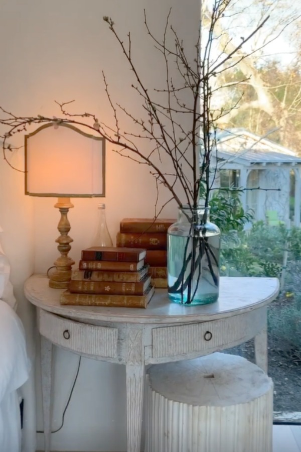 Romantic bedroom at Patina Farm (a European country farmhouse by Giannetti Home) has antiques from Sweden, sumptuous linens, a French stone fireplace, and rustic elegant charm. #interiordesign #bedroomdesign #europeancountry #frenchfarmhouse #patinafarm #brookegiannetti