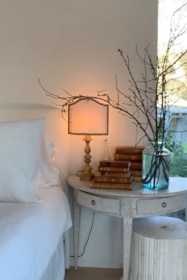 Romantic bedroom at Patina Farm (a European country farmhouse by Giannetti Home) has antiques from Sweden, sumptuous linens, a French stone fireplace, and rustic elegant charm. #interiordesign #bedroomdesign #europeancountry #frenchfarmhouse #patinafarm #brookegiannetti