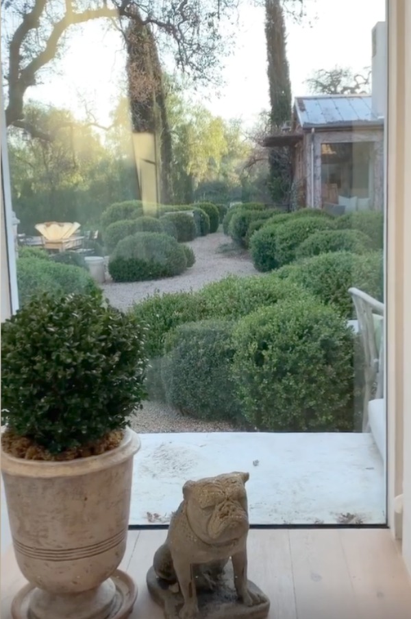 Beautiful French farmhouse style gardens at Patina Farm in Ojai, California with pea gravel and boxwood. #patinafarm #frenchfarmhouse #frenchcourtyard #gardendesign #europeancountry