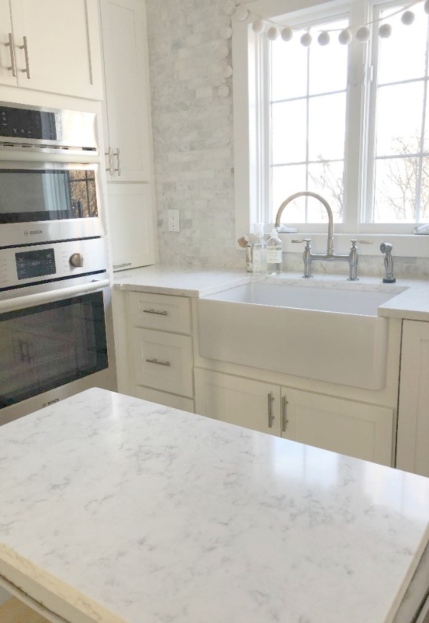 Minuet Viatera quartz countertop in our classic white kitchen with Shaker cabinets and stainless appliances. #hellolovelystudio #whitequartz #countertops #kitchendesign #minuet #viateraquartz #lgviatera