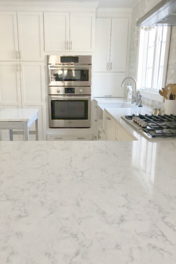 Minuet Viatera quartz countertop in our classic white kitchen with Shaker cabinets and stainless appliances. #hellolovelystudio #whitequartz #countertops #kitchendesign #minuet #viateraquartz #lgviatera