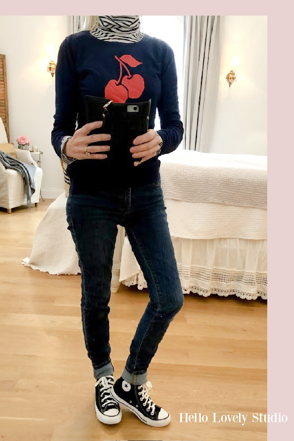 Hello Lovely Studio casual winter fashion over 50 - navy cherry sweater, jeans and Converse high tops. #fashionover50 #casual #navy