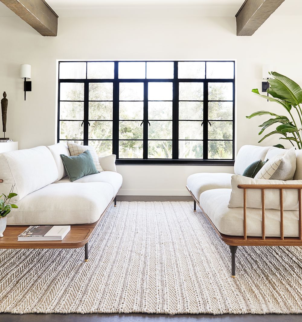 Cozy white living room with rustic accents and an airy coastal organic Cali vibe - Lulu & Georgia. #whitedecor #livingroom #casualstyle #interiordesign #neutraldecor