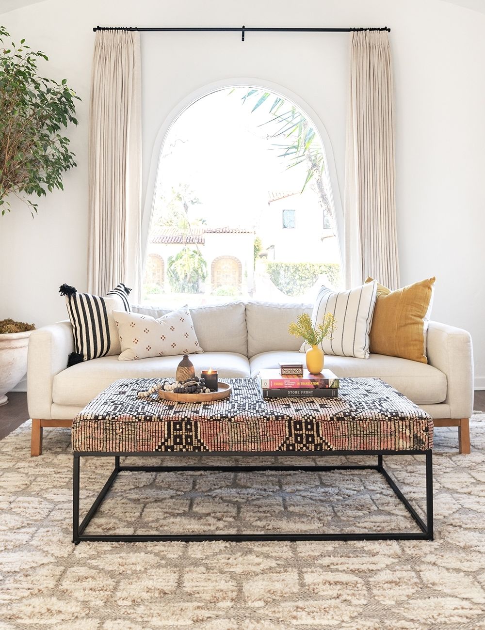 Eclectic modern cozy living room with white sofa and assorted pillows - Lulu and Georgia. #livingroom #interiordesign moderncasual