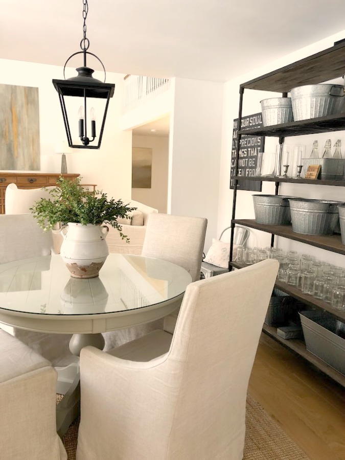 Belgian linen slope arm chairs around round dining table in our home - Hello Lovely Studio. #diningroom #modernfarmhouse #belgianlinen #interiordesign