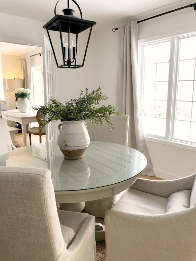 Belgian linen slope arm chairs around round dining table in our home - Hello Lovely Studio. #diningroom #modernfarmhouse #belgianlinen #interiordesign