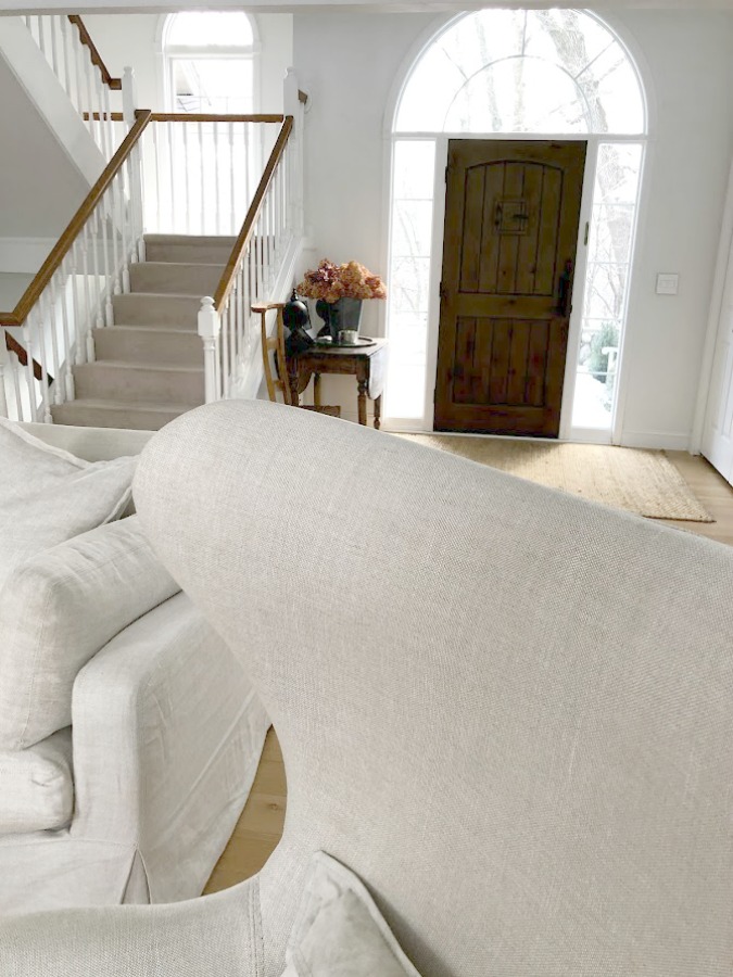 White oak hardwood flooring and Belgian linen upholstered Copenhagen egg chair (RH) in our living room - Hello Lovely Studio. #eggchair #belgianlinen #belgianstyle #livingroom #whiteoak #hardwoodfloor