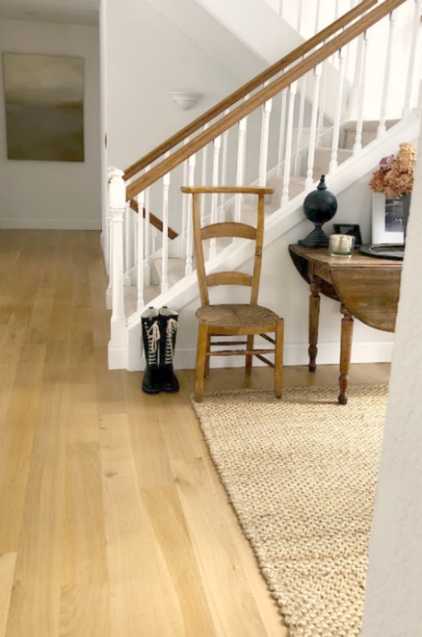 Neutral decor and vintage style in our European country style entry with white oak hardwood flooring - Hello Lovely Studio. #europeancountry #entry #whiteoak #hardwoodflooring