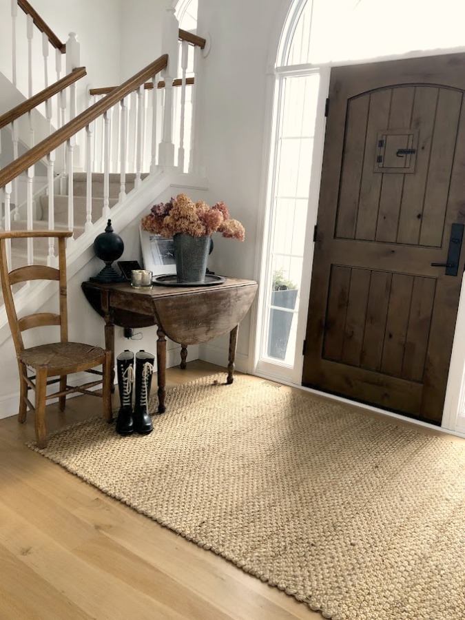 Neutral decor and vintage style in our European country style entry with white oak hardwood flooring - Hello Lovely Studio. #europeancountry #entry #whiteoak #hardwoodflooring