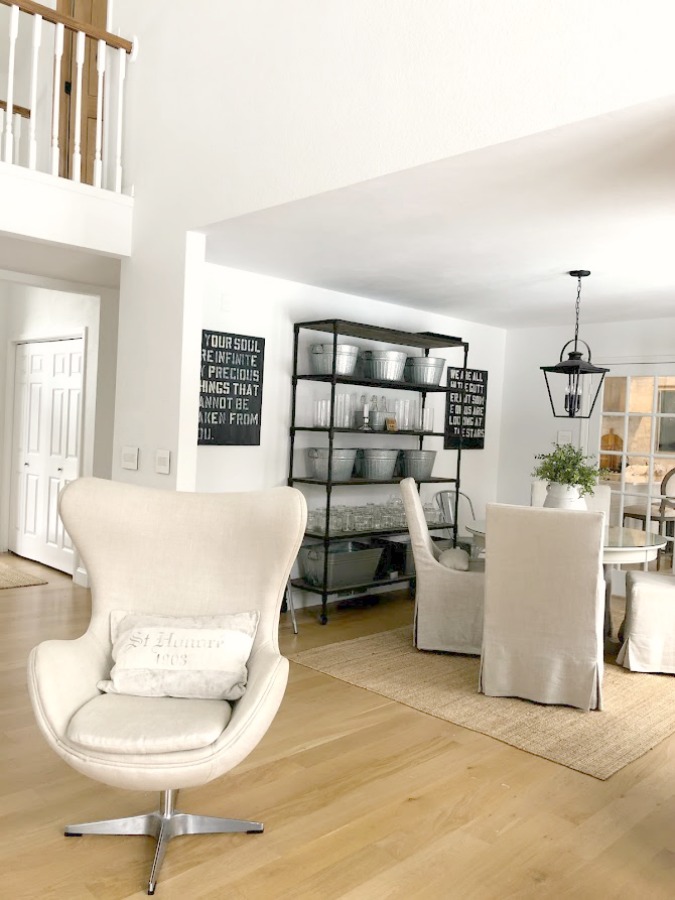 Belgian style egg chair and dining room in our renovated home - Hello Lovely Studio. #belgianstyle #europeancountry #diningroom #whiteoakhardwood