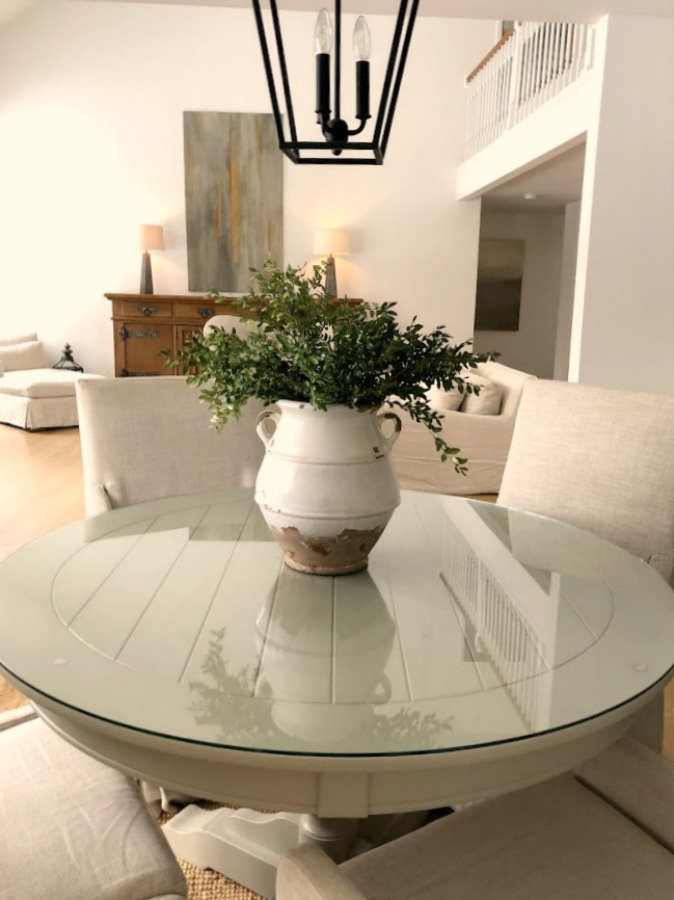 Belgian linen slope arm chairs around round dining table in our home - Hello Lovely Studio. #diningroom #modernfarmhouse #belgianlinen #interiordesign