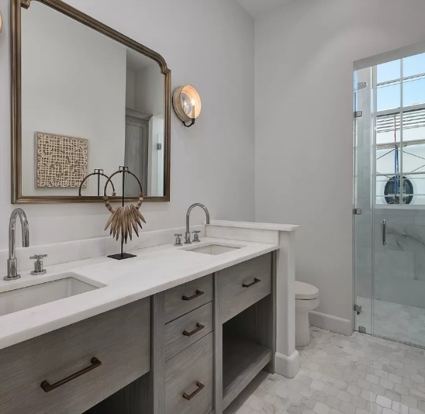 Luxurious finishes in a timeless bathroom at a coastal Alys Beach home by Domin Bock. #bathroomdesign #coastalstyle #luxuriousbath #interiordesign