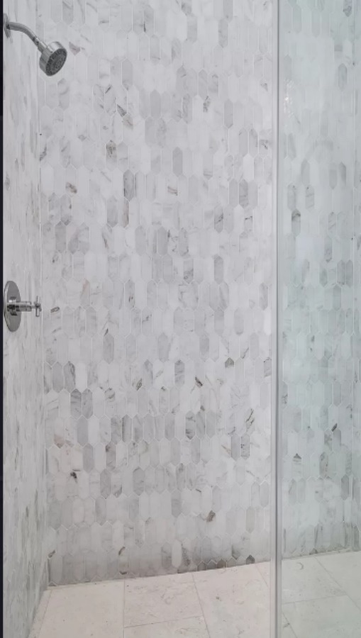 Magnificent marble mosaic tiled shower in a luxurious bathroom in a coastal inlet home by Damien Bock. #marblemosaictile #marbleshower #luxuriousshower #bathroomdesign