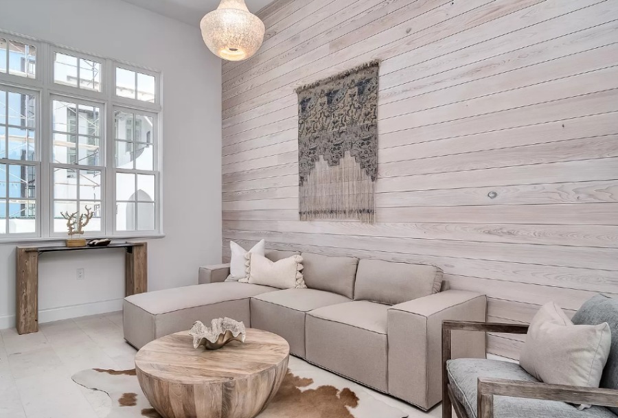 Luxurious neutral and serene den with grey wood statement wall in a coastal home by Domin Bock. #alysbeach #coastalhome #luxurioushome #warmminimal #den #interiordesign