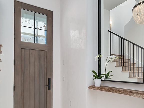 Warm, sophisticated, minimal and luxurious entry with grey wood door in a coastal home (Alys Beach) by Domin Bock. #interiordesign #entry #housedesign #warmminimal #luxurioushome