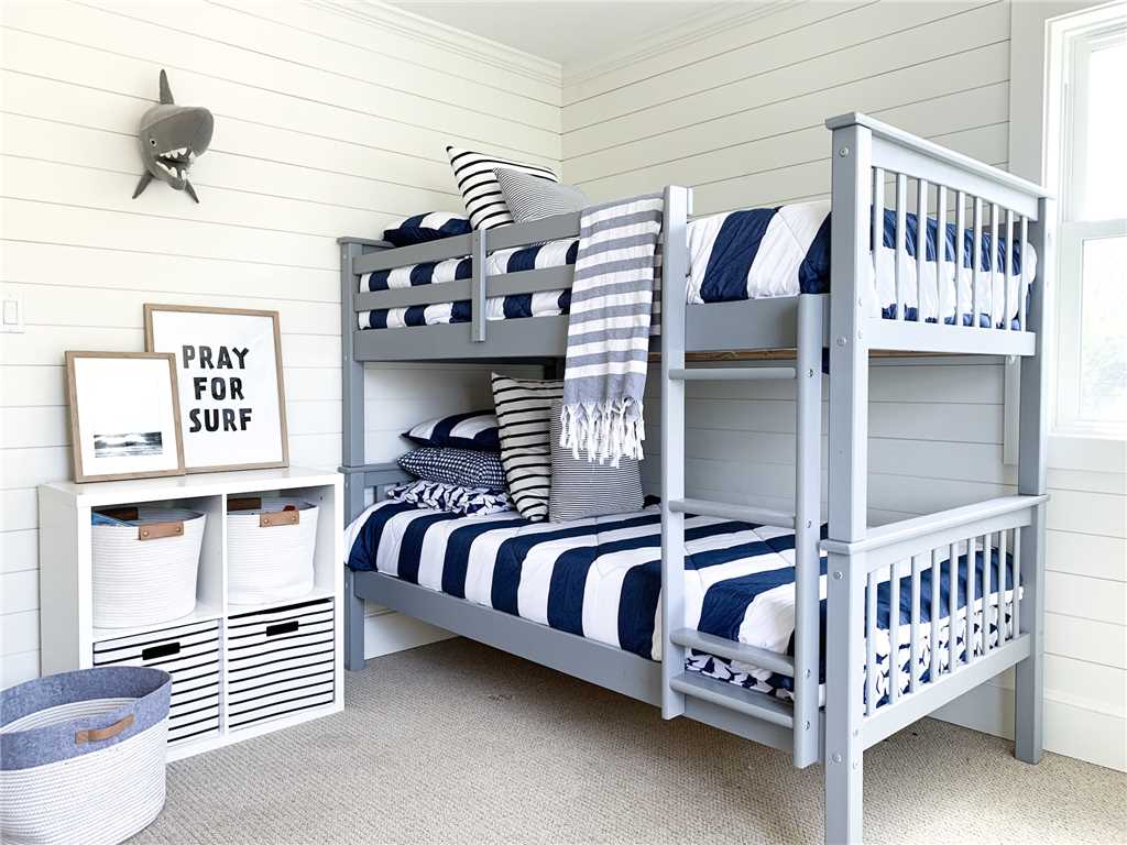 Charming blue and white classic coastal bedroom with shiplap - Summerfell Cottage in NC. #bunkroom #coastalstyle #shiplapwall #blueandwhite #interiordesign #bedroomdecor