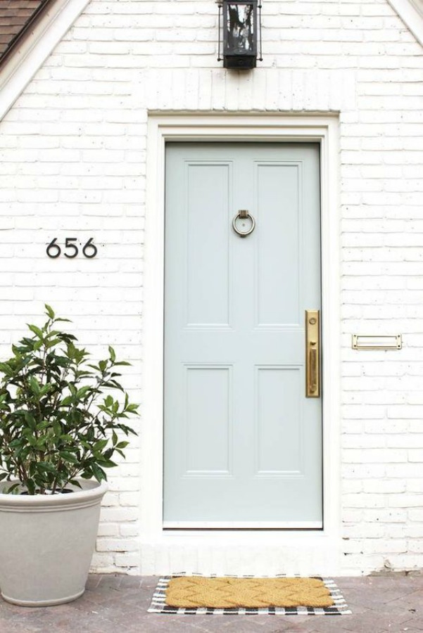 Greyhound by Benjamin Moore on front door of beautiful white Tudor home exterior in Denver by Studio McGee. #greyhound #benjaminmooregreyhound #paintcolors #greypaintcolors