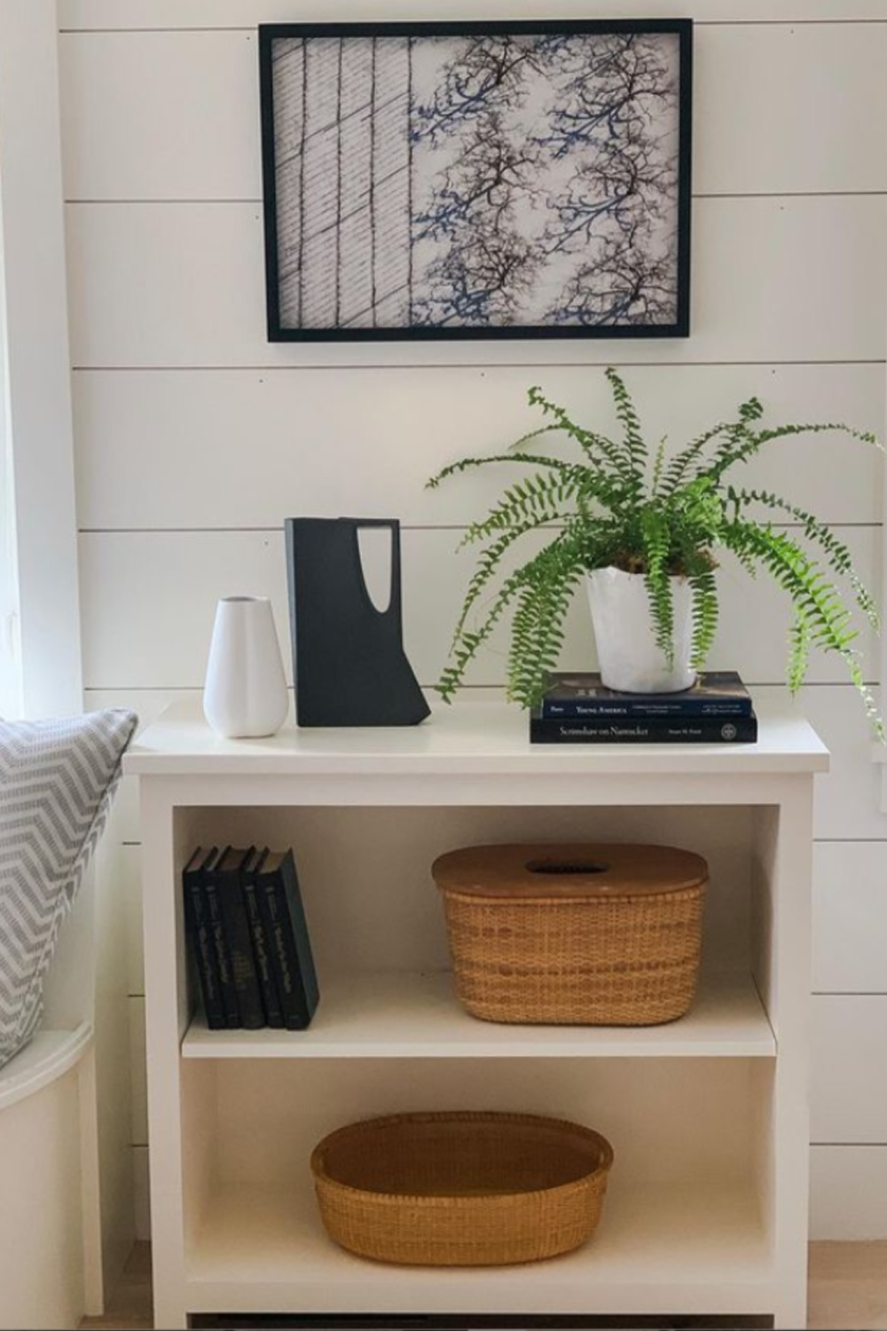 Black and white vignette with white shelves, shiplap, and black accents - design by Sherry Hart. #modernfarmhouse #interiordesign #blackandwhite