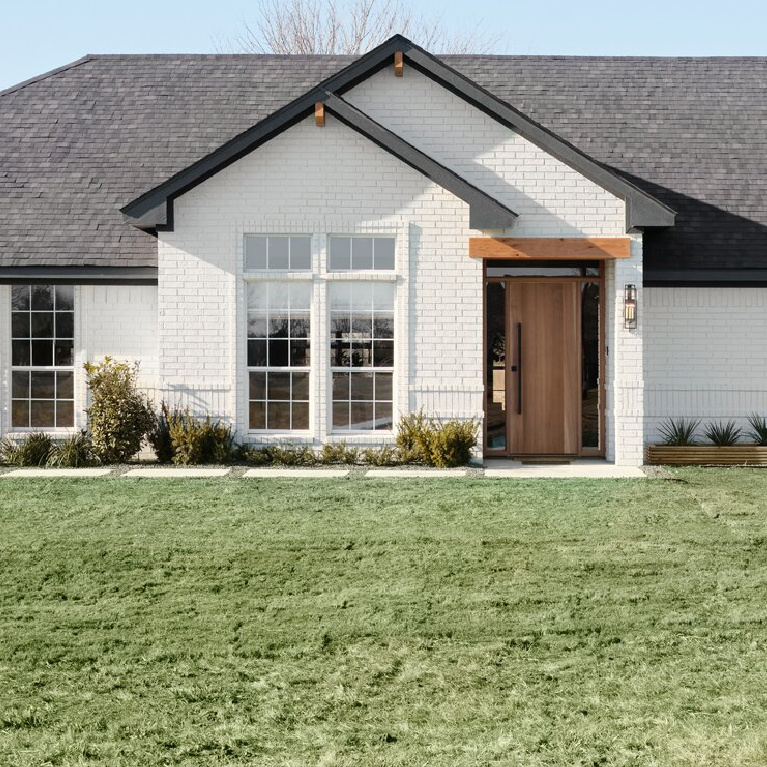 Bleached (Magnolia Home) paint color on white brick "after" house from episode 1, Fixer Upper Welcome Home. #paintcolors #bleached #exteriorcolors