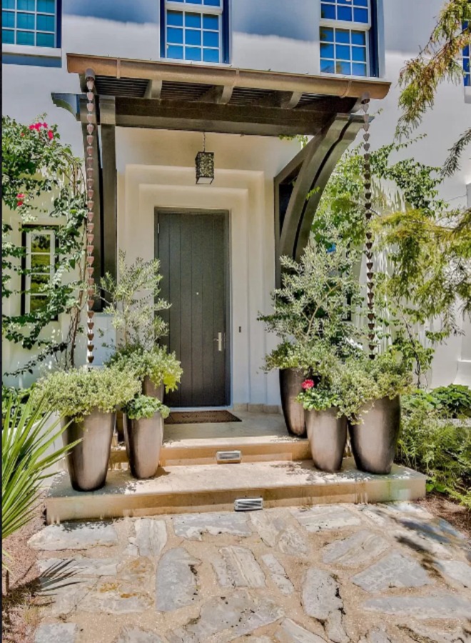 Lush and sophisticated front entry to a magnificent coastal home (Alys Beach) by Domin Bock. #houseexterior #housedesign #coastalhome #alysbeach