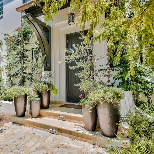 Lush and sophisticated front entry to a magnificent coastal home (Alys Beach) by Domin Bock. #houseexterior #housedesign #coastalhome #alysbeach