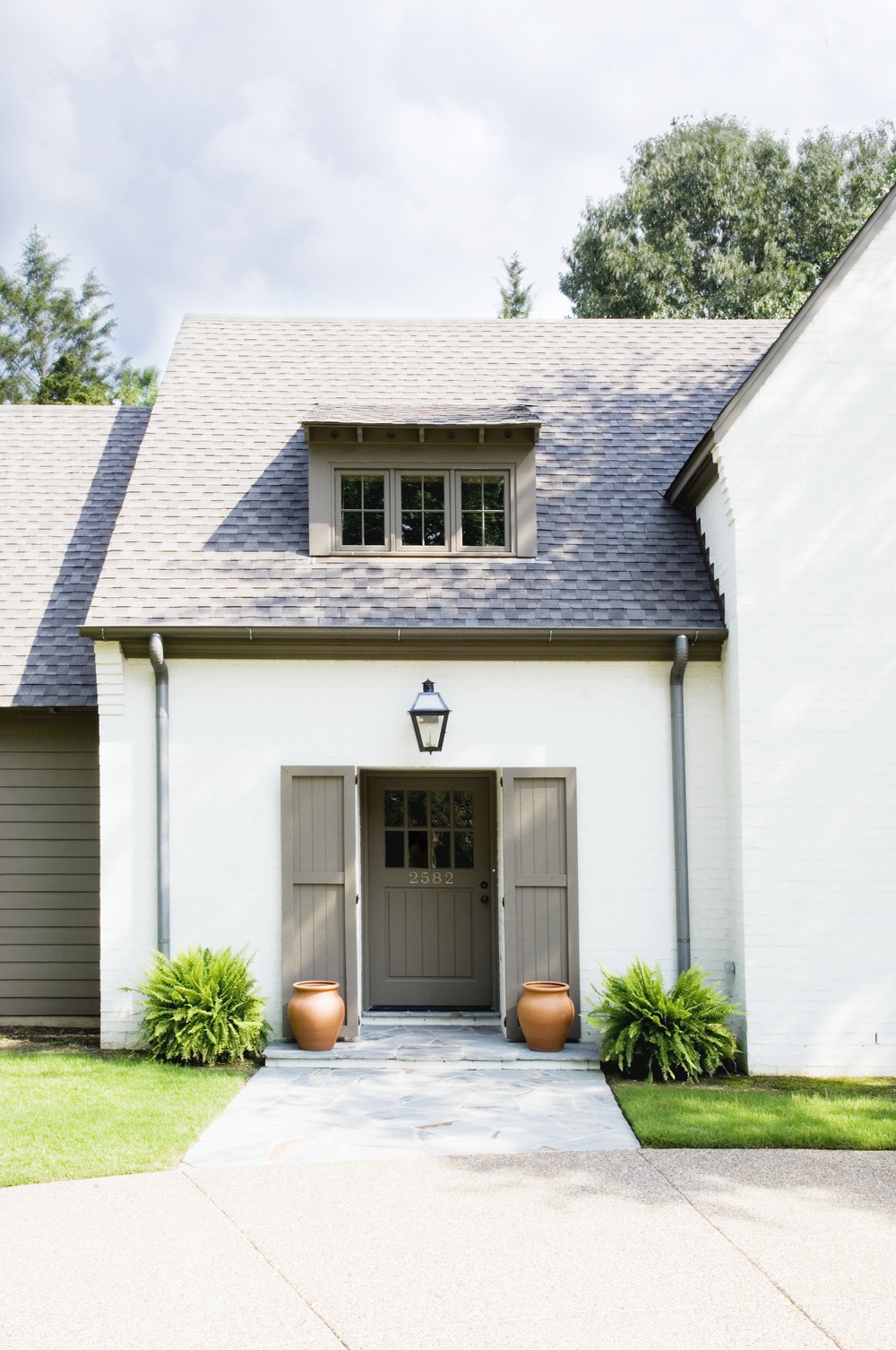 Sherwin Williams Snowbound is the white paint color on this house exterior and shutters are painted SW Jogging Path - David Anderson Architect. #snowbound #joggingpath #sherwinwilliams #paintcolors #houseexteriors