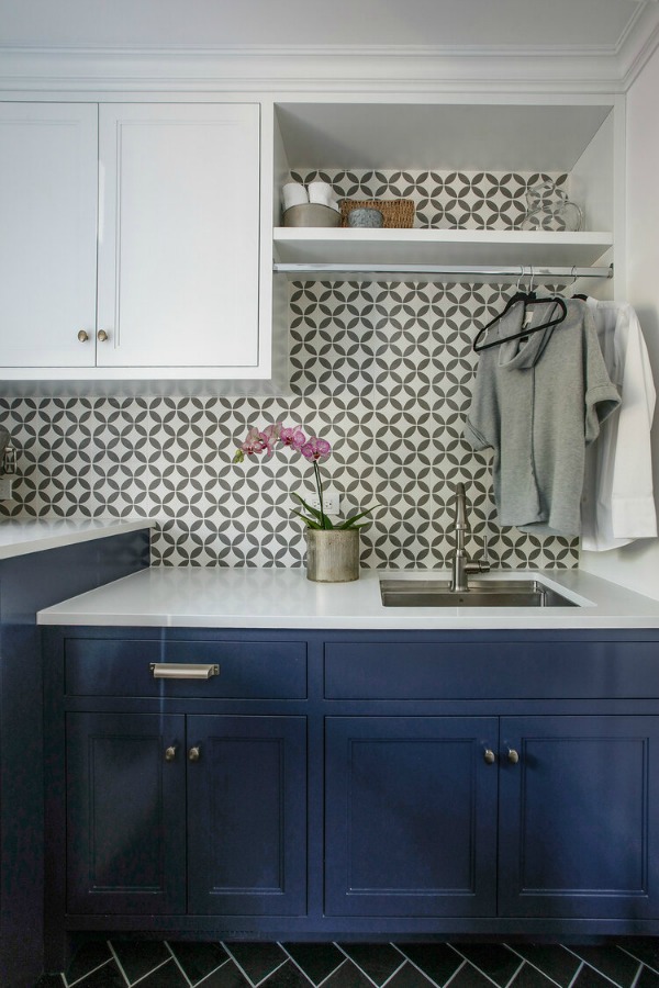 Laundry room with bold tiled walls and blue cabinets - Edward Deegan Architects. #laundryroom #blueandwhite #bluecabinets