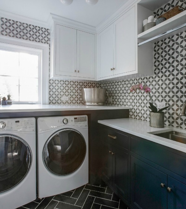 Laundry room with bold tiled walls and blue cabinets - Edward Deegan Architects. #laundryroom #blueandwhite #bluecabinets