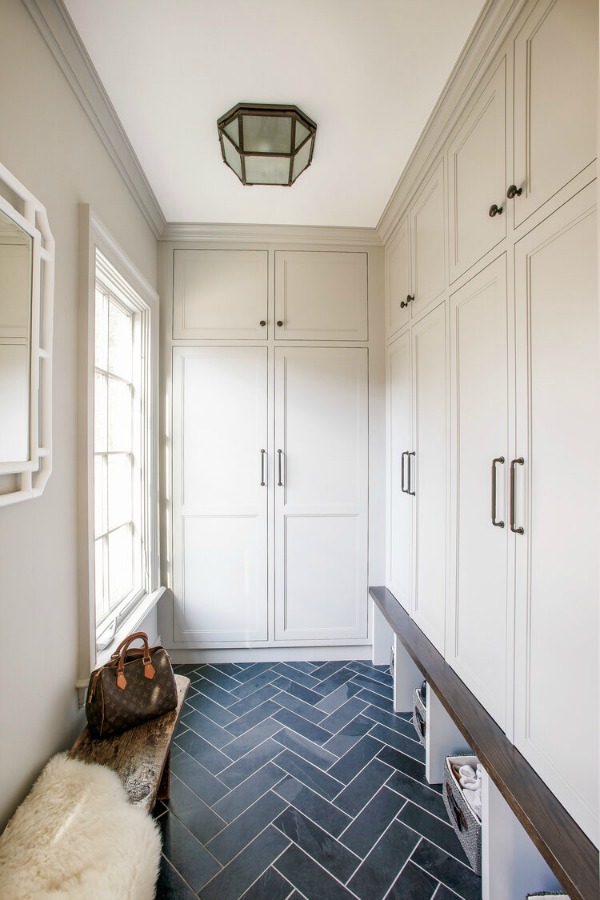 Stunning mudroom with built-ins, custom millwork, and bold blue herringbone tile floor - Edward Deegan Architects. #mudroom #builtins #blueandwhite #interiordesign