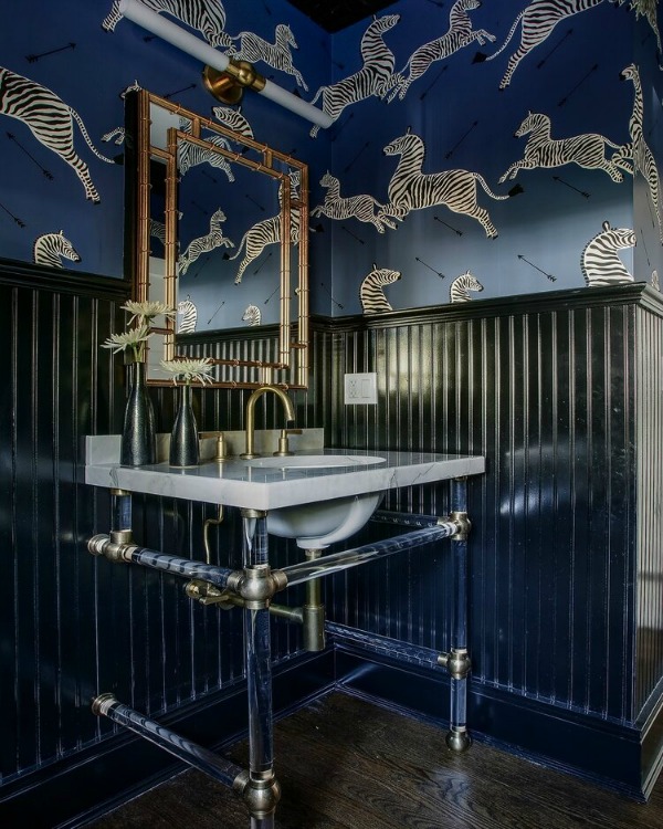 Stunning bathroom design with bold blue zebra wall covering, console sink, and gold hardware - Edward Deegan Architects. #powderbath #bathroomdesign #bluebathroom #interiordesign