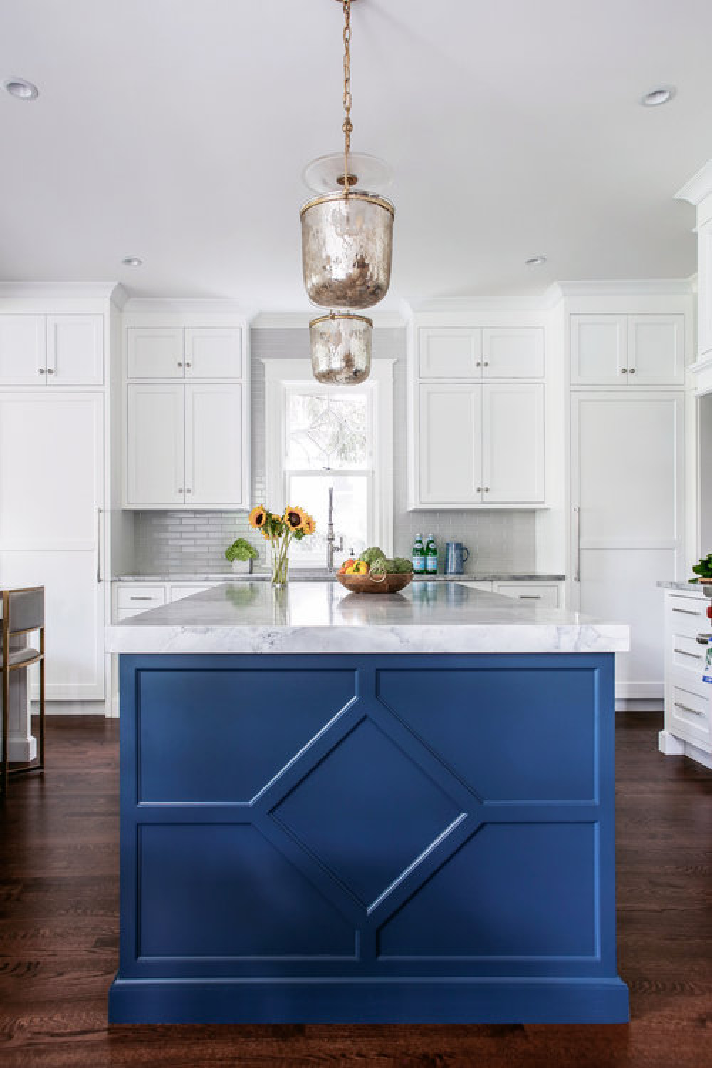 Classic blue painted island in a traditional style white kitchen by Edward Deegan Architects.