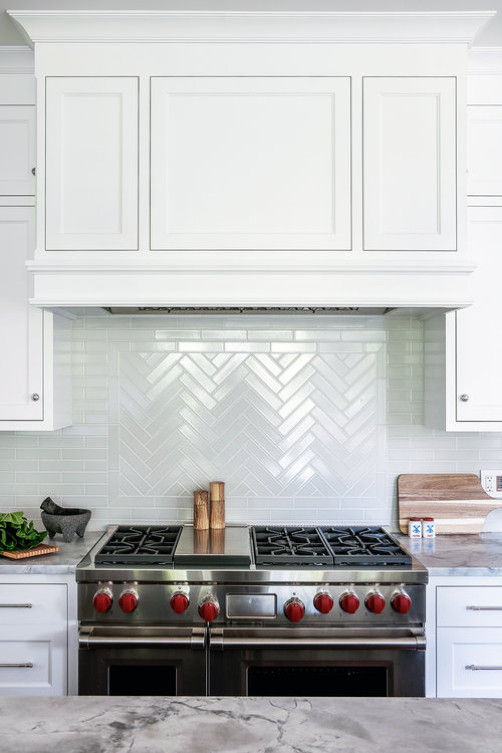 Classic white kitchen with professional stainless range and white tiled backsplash - Edward Deegan Architects.