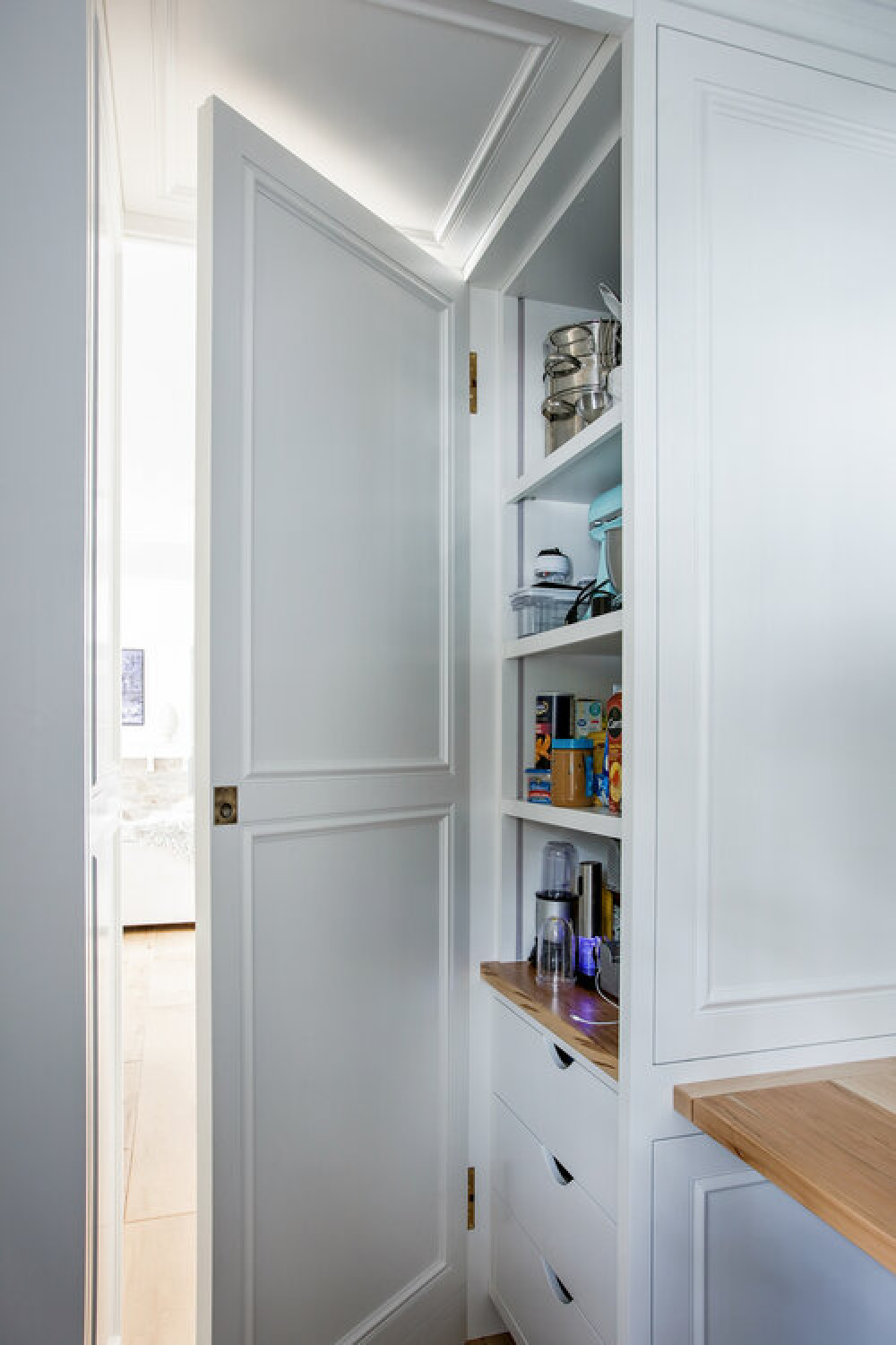 Detail of interior of a pantry in a classic white kitchen by Edward Deegan Architects. Find more blue kitchen ideas in this story!