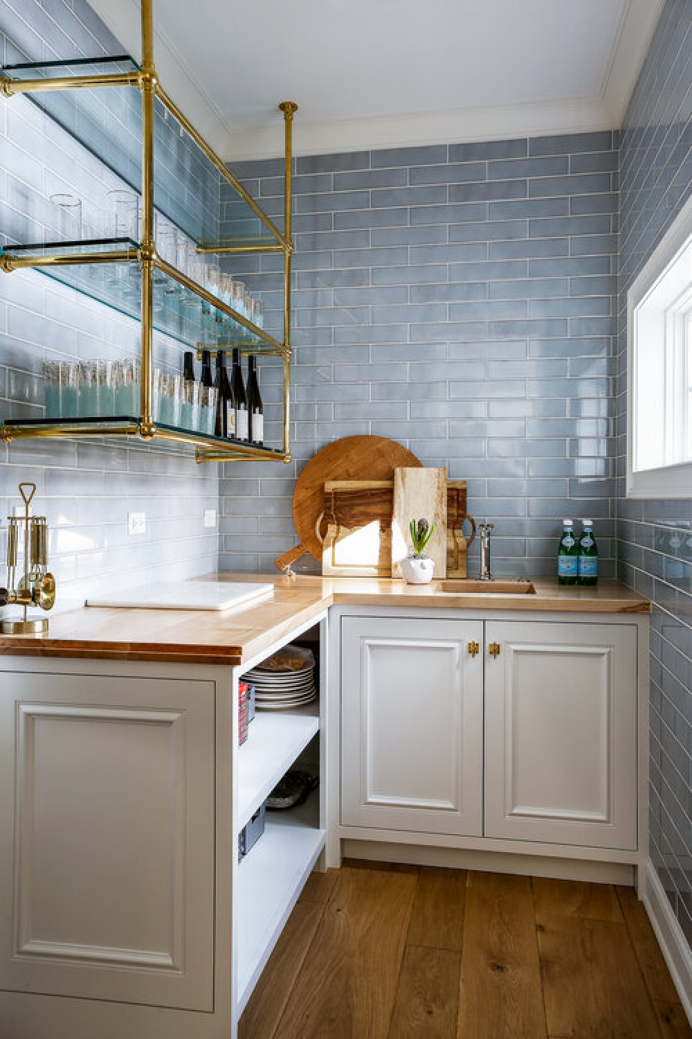 Beautiful blue kitchen ideas - tiled wall in a butler pantry with open shelving and wood counters - design by Edward Deegan Architects. #butlerpantry #bluetile #bluebacksplash