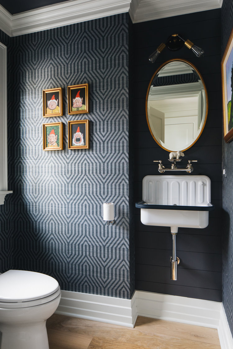 Dramatic and whimsical, a black and white modern farmhouse powder bath in a magnificent home by Edward Deegan Architects sings! Notice the charming farm sink! #bathroomdesign #modernfarmhouse #blackandwhite #powderbath