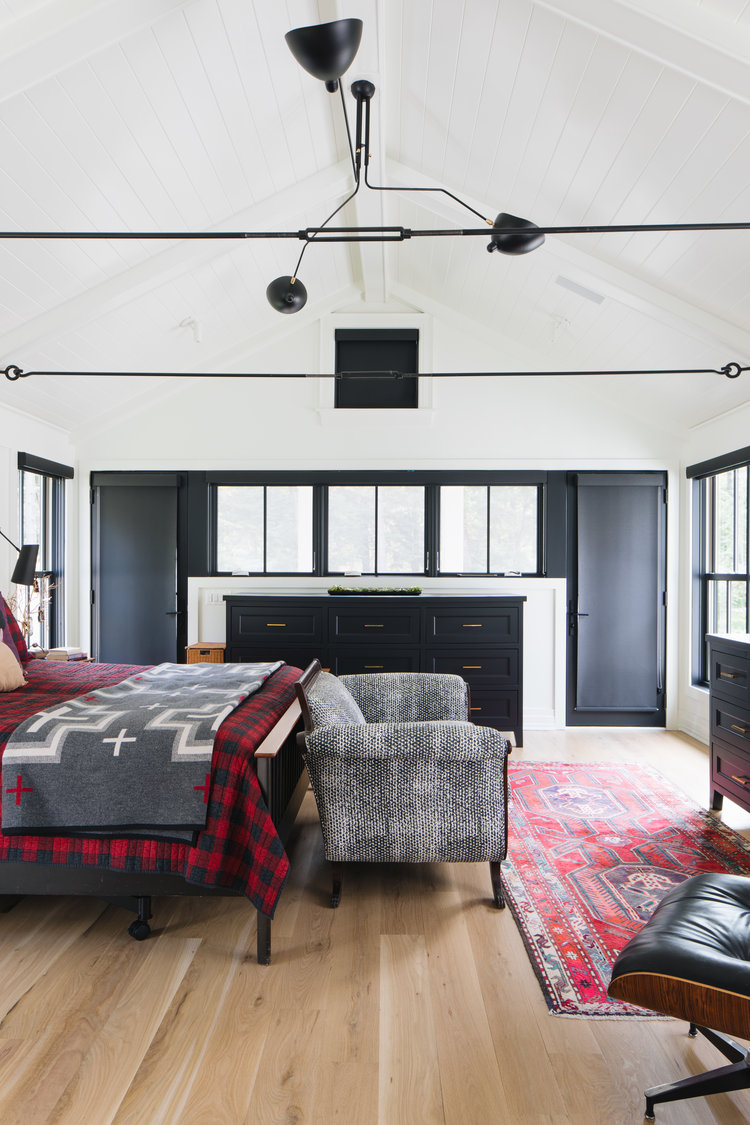 Richly dramatic, this modern farmhouse bedroom with black and white has exceptional architectural interest, imagined by Edward Deegan. #modernfarmhouse #blackandwhite #bedroomdesign #interiordesign