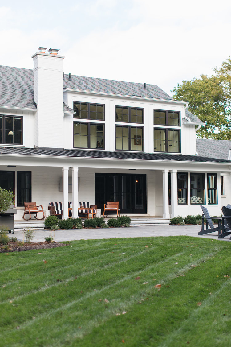 White and black modern farmhouse exterior with black doors and black windows - Edward Deegan Architects. #modernfarmhouse #blackandwhite #houseexteriors #housedesign