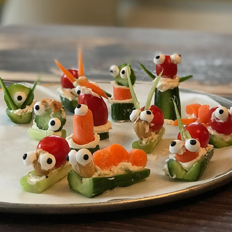 Whimsical vege appetizers with googlie eyes resembling the art of Jenny Sweeney.